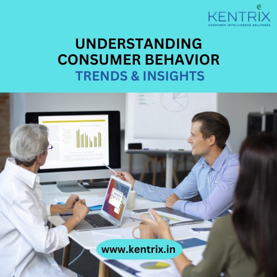 "Business professionals analyzing consumer behavior trends and insights on a computer screen in a modern office setting. Kentrix logo.